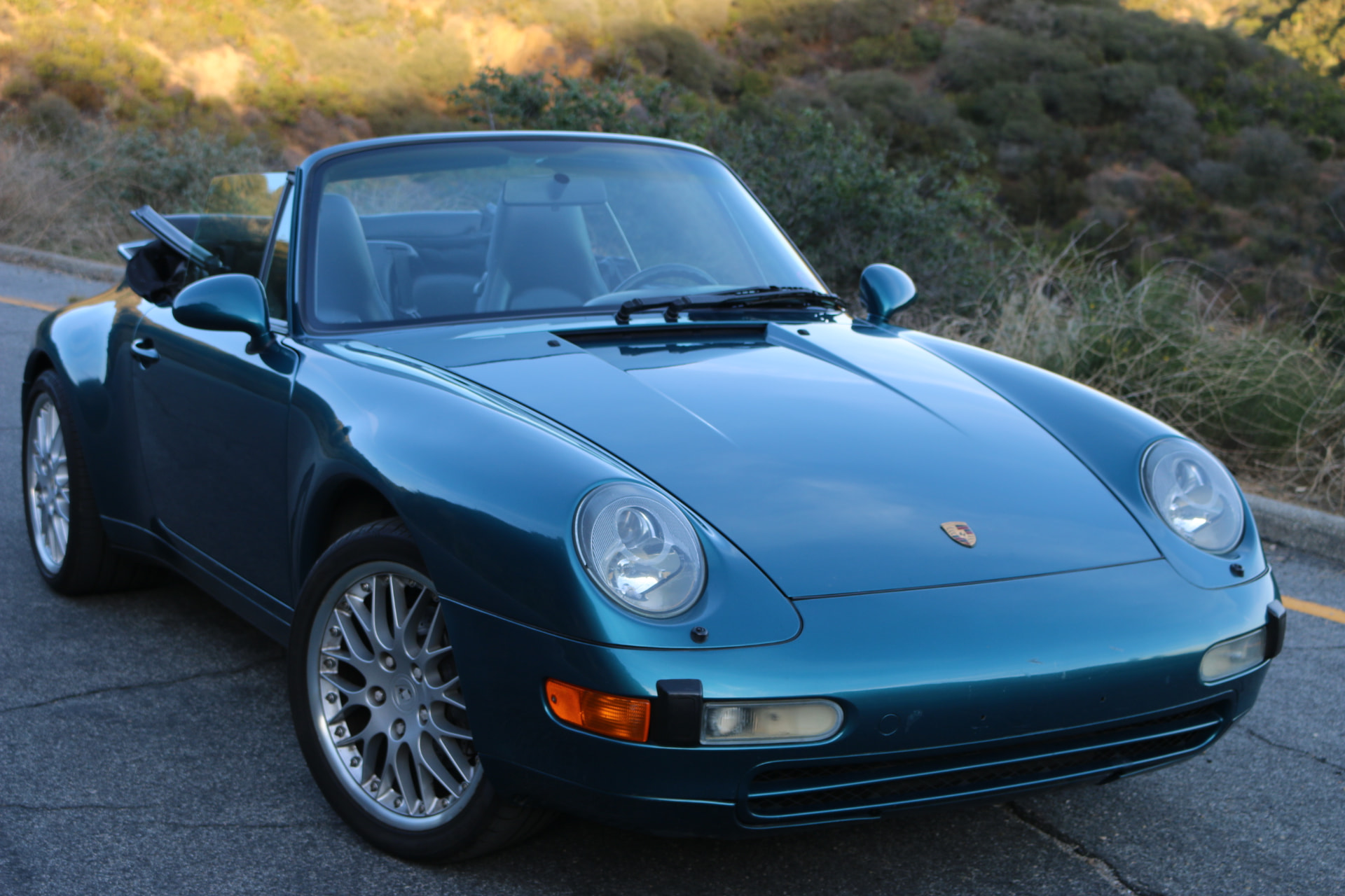 1996 Porsche 993 Carrera Cabriolet in Turquoise Blue Metallic at golden hour